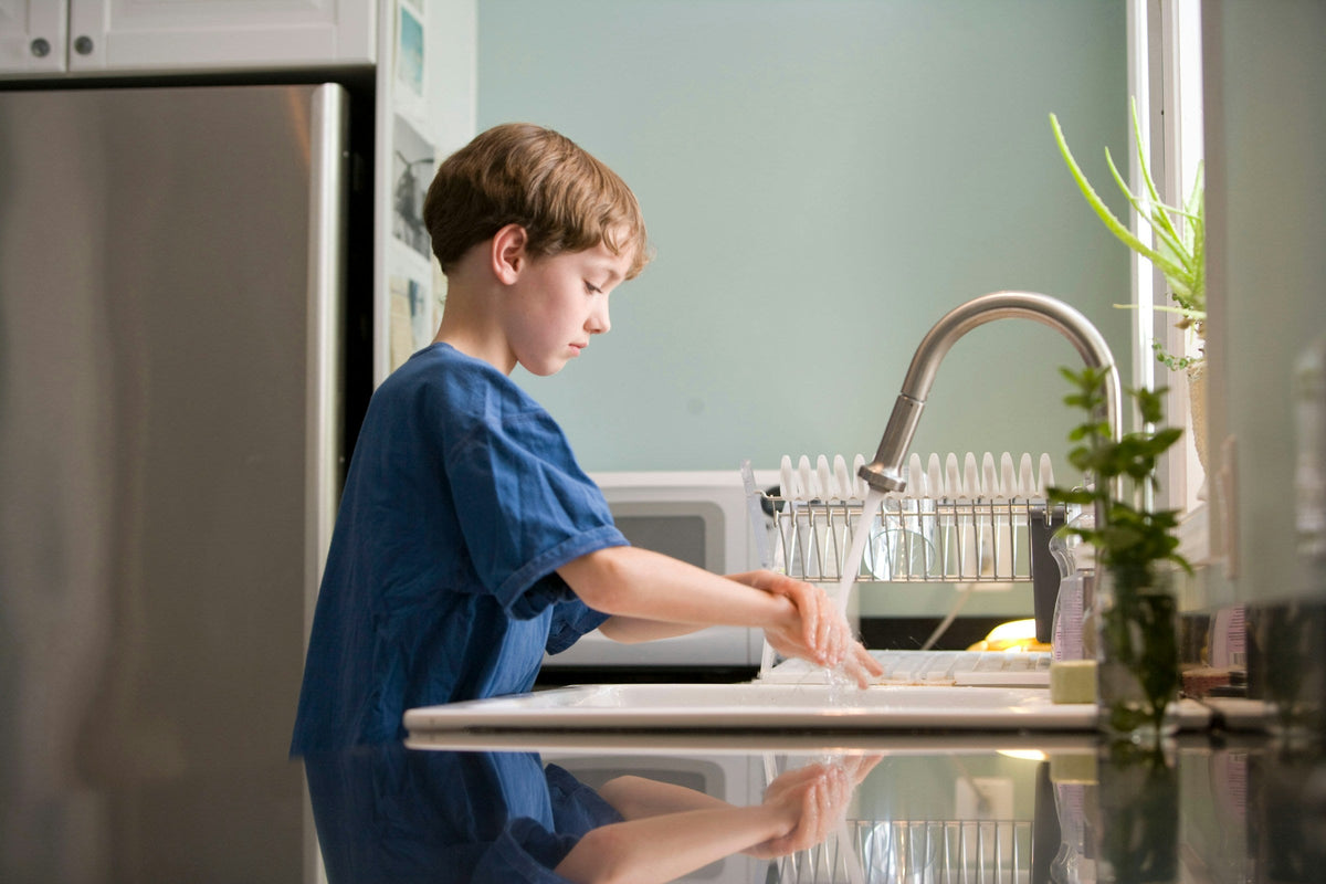 Boy washing his hands at the sink