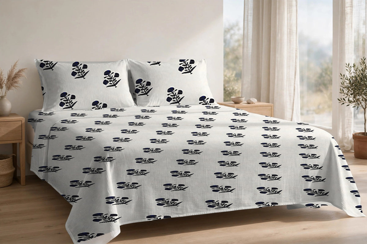 Phool Booti Kaala cotton bedsheet on a made king bed, with matching pillow covers