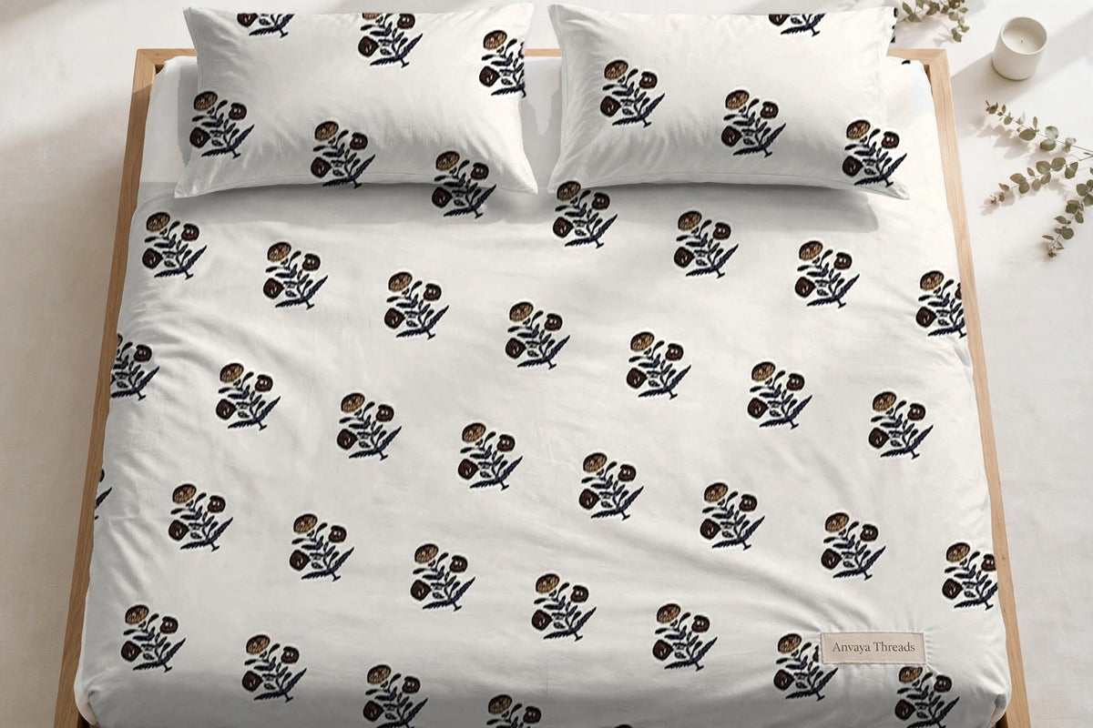 Kali Booti Sona bedsheet seen from above, with the pillow covers at the head of the bed