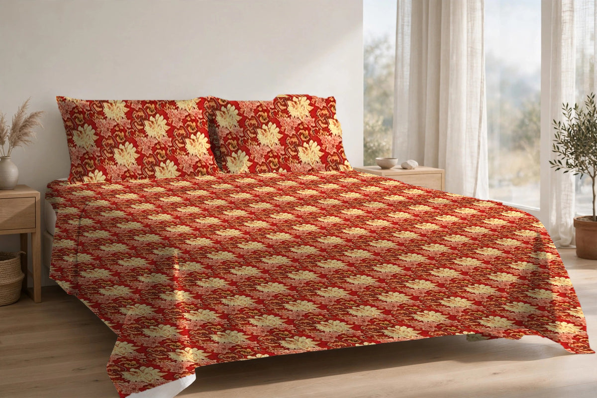 Gulmohar Kesar cotton bedsheet on a made king bed, with matching pillow covers