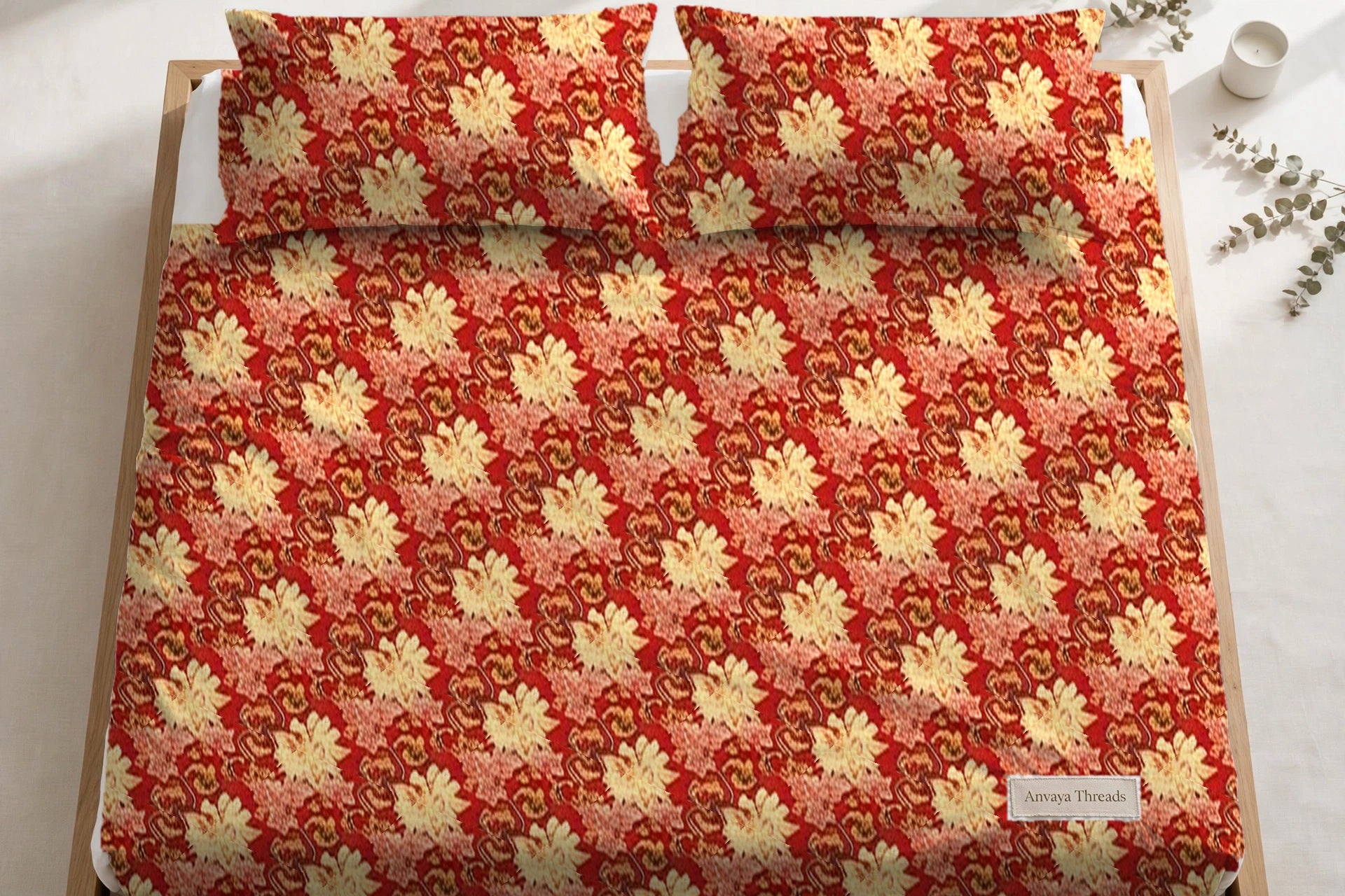 Gulmohar Kesar bedsheet seen from above, with the pillow covers at the head of the bed