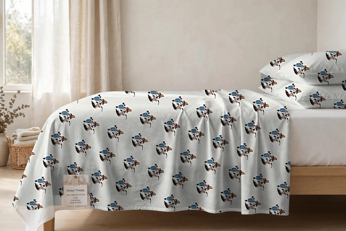 Gulab Kali Rangoli bedsheet seen from the side, falling over the edge of the bed