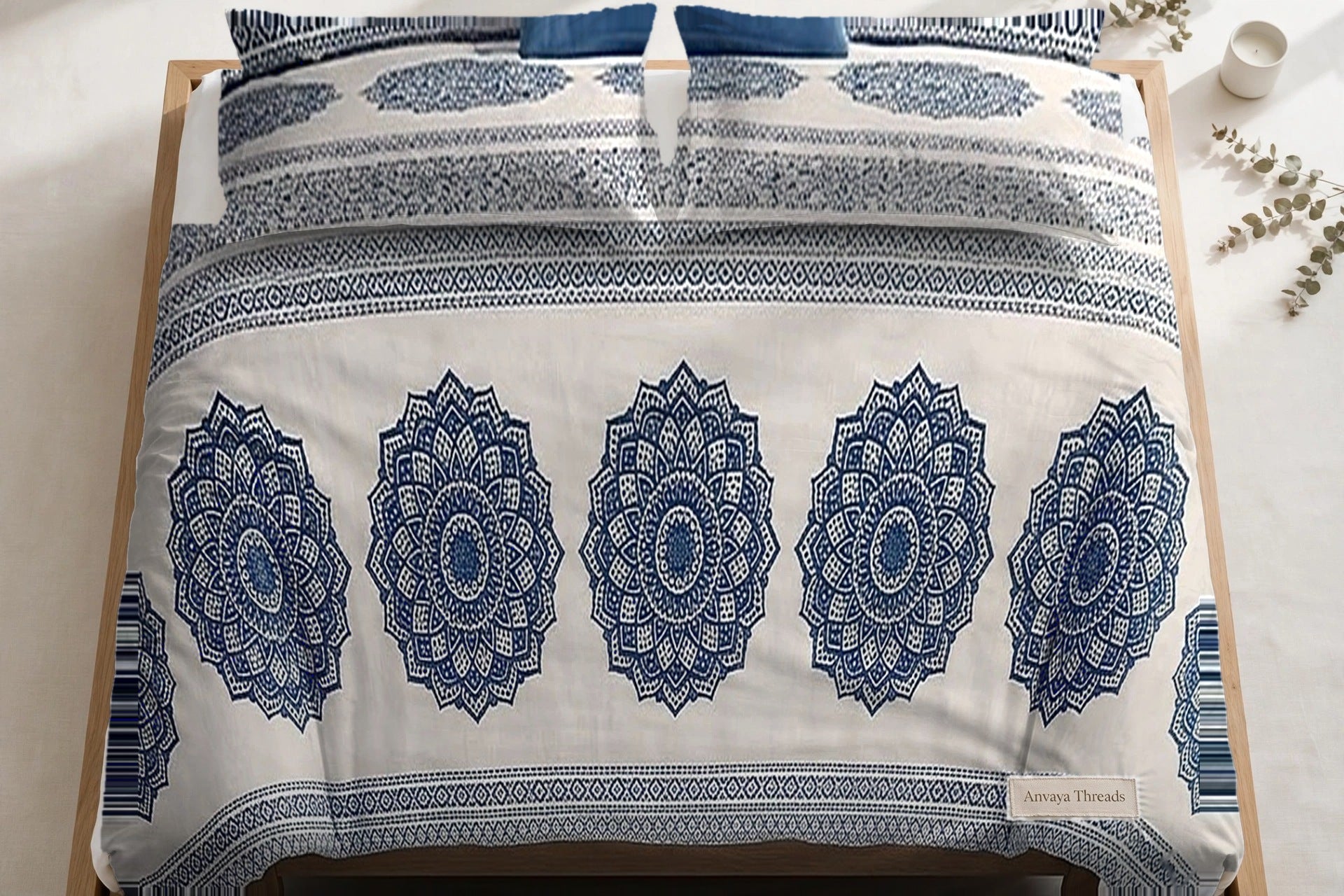 Chakra Mandala Neel bedsheet seen from above, with the pillow covers at the head of the bed