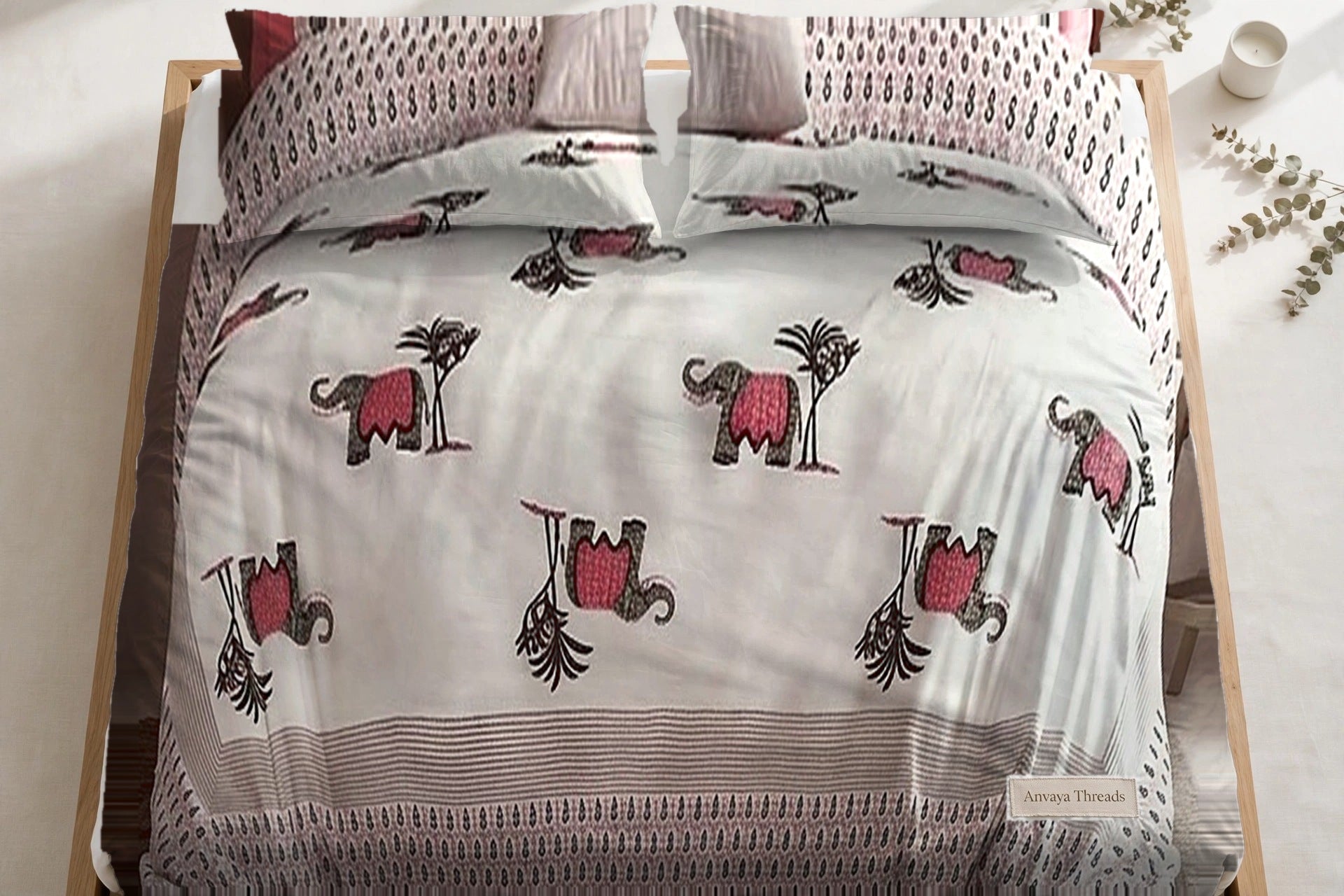 Hathi Sawari Gulab bedsheet seen from above, with the pillow covers at the head of the bed