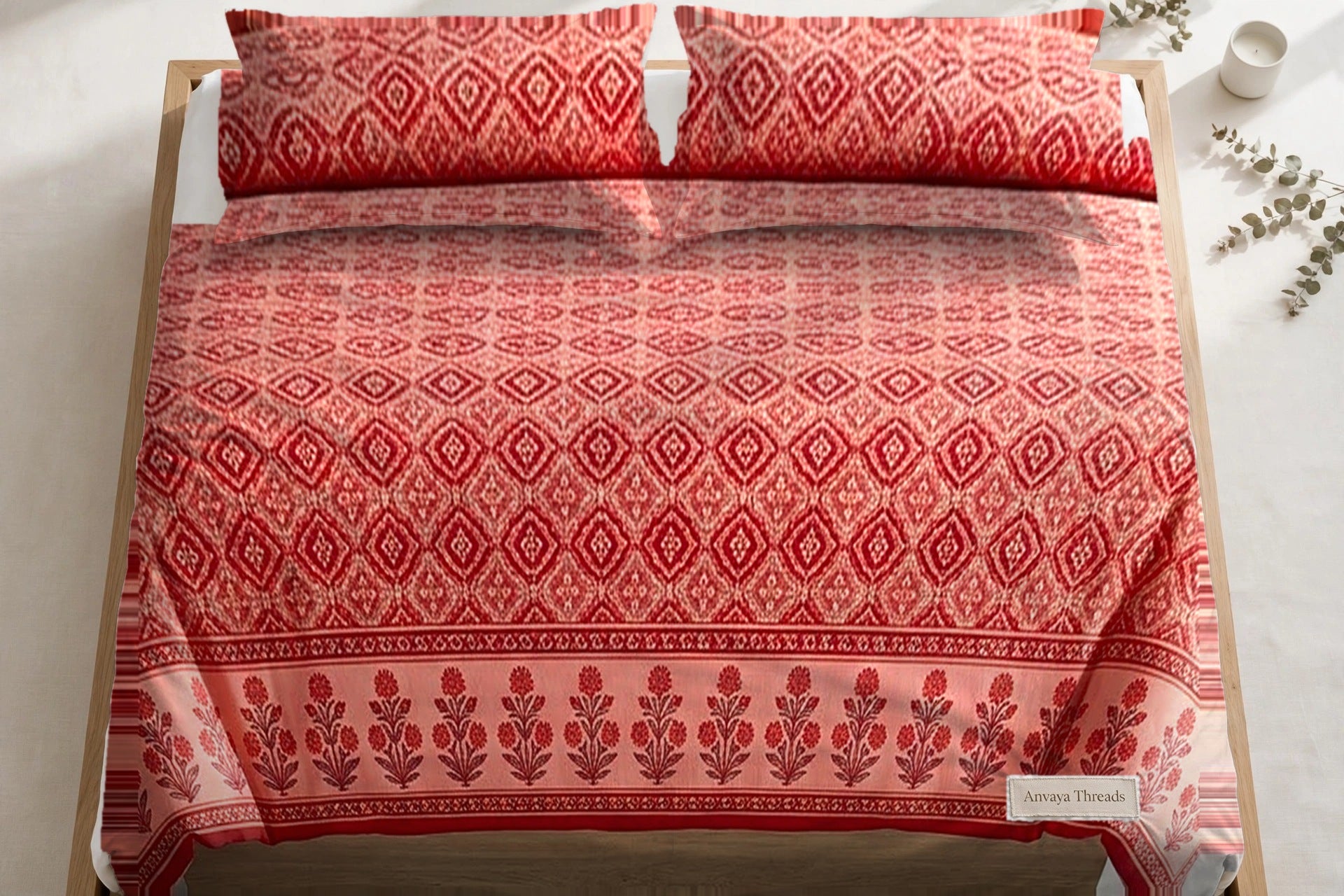 Kinari Booti Sindoor bedsheet seen from above, with the pillow covers at the head of the bed