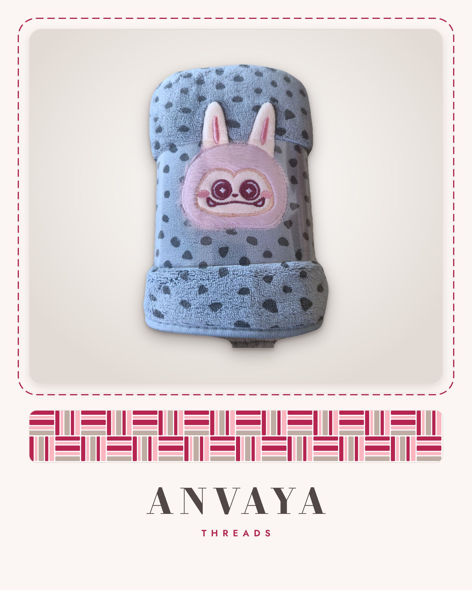 Slate Blue Dot Bunny kids' hand towel, rolled in a clear wrap with a bunny patch